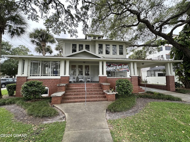 view of front of house with covered porch and a carport