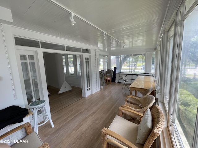 sunroom featuring rail lighting