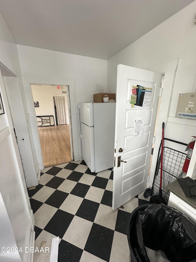 interior space featuring white cabinetry and white fridge