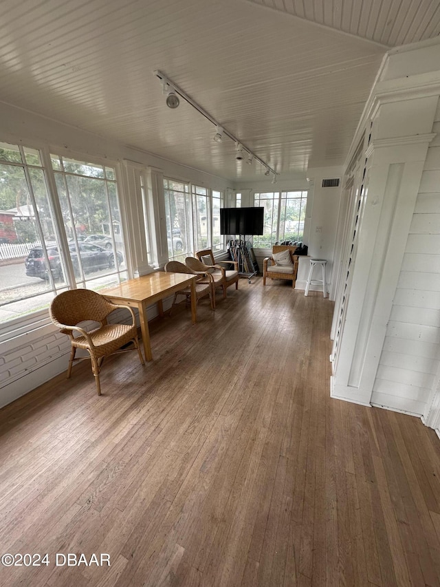 unfurnished sunroom with track lighting