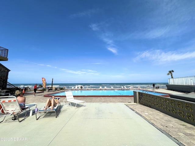 view of patio / terrace with a water view and a community pool