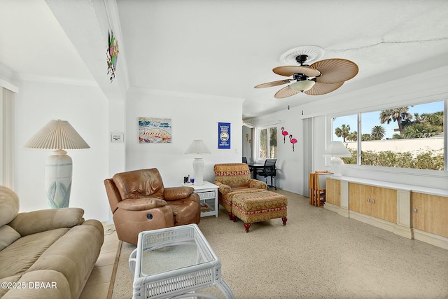 living room with light speckled floor, crown molding, and ceiling fan