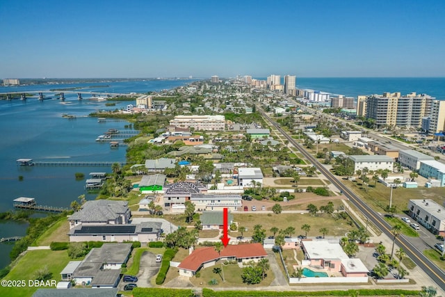 birds eye view of property with a city view and a water view