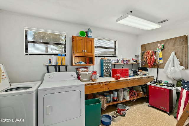 laundry room with cabinet space, washing machine and dryer, and visible vents