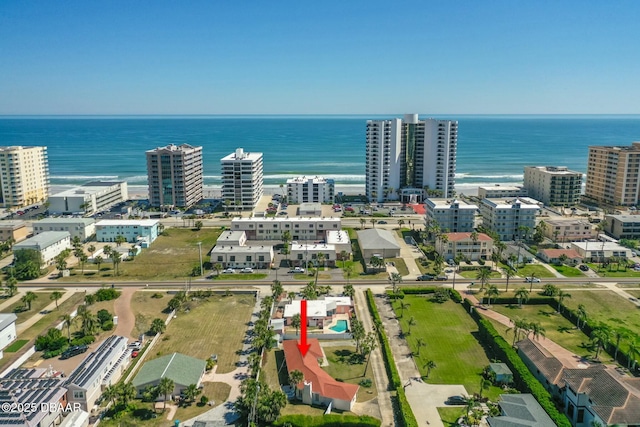 birds eye view of property featuring a water view and a view of city