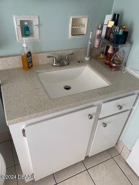 bathroom with tile patterned floors and vanity