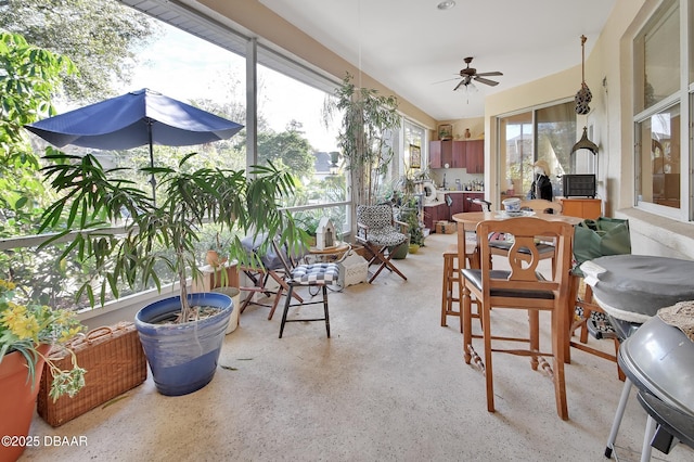 sunroom featuring ceiling fan