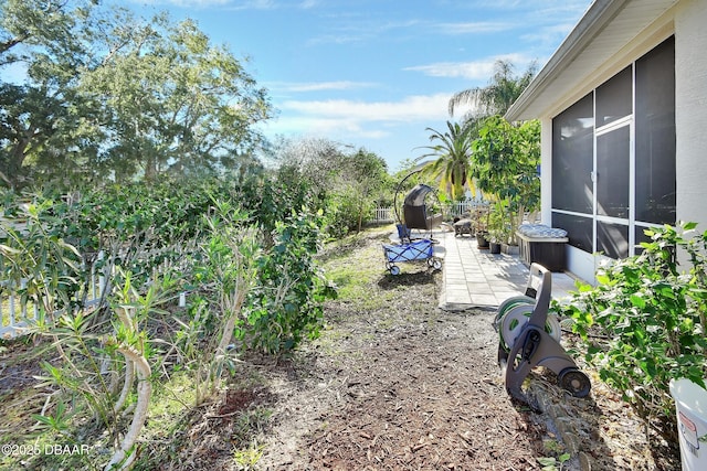 view of yard featuring a sunroom and a patio area