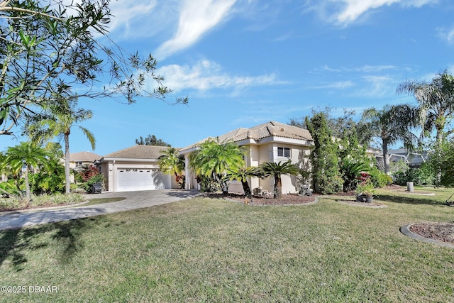 view of front of home with a garage and a front yard