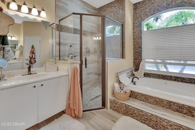 bathroom featuring independent shower and bath and vanity