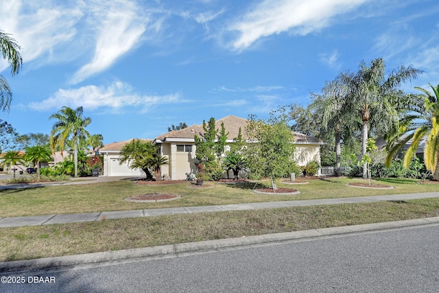 view of front of home featuring a garage and a front lawn