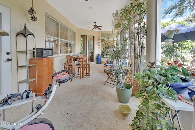 sunroom / solarium featuring ceiling fan