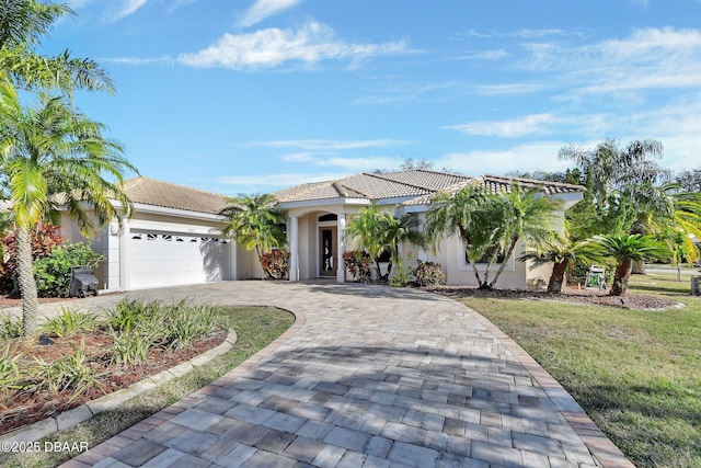 mediterranean / spanish-style house with a garage and a front yard