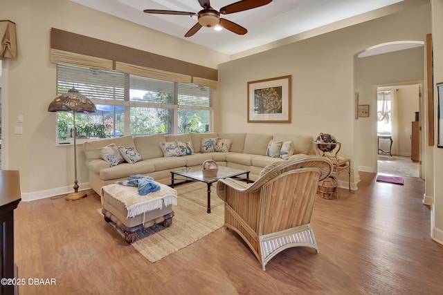 living room featuring wood-type flooring and ceiling fan