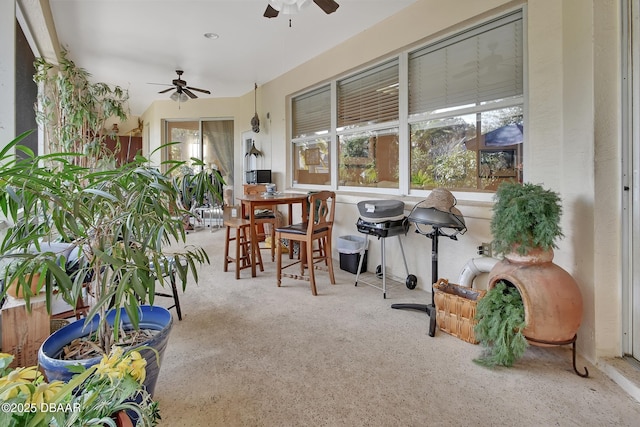 sunroom featuring ceiling fan