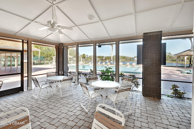 unfurnished sunroom with ceiling fan