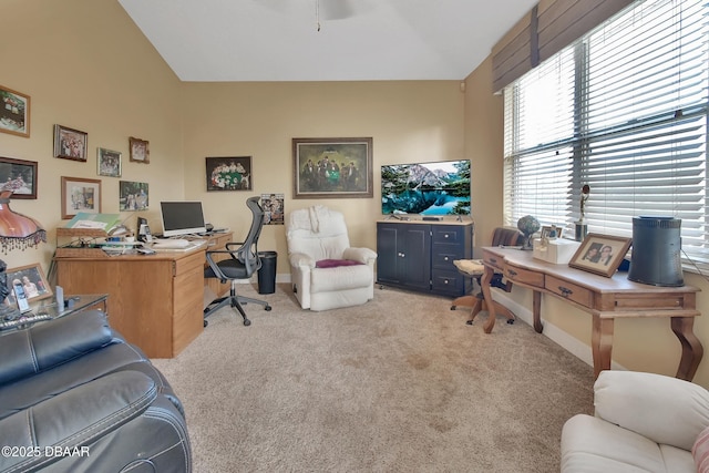 carpeted office featuring vaulted ceiling