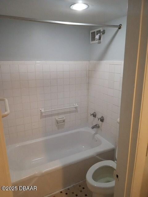 bathroom with tile patterned floors, toilet, and shower / bathing tub combination