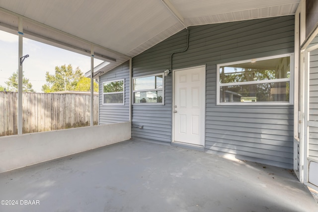 unfurnished sunroom with vaulted ceiling