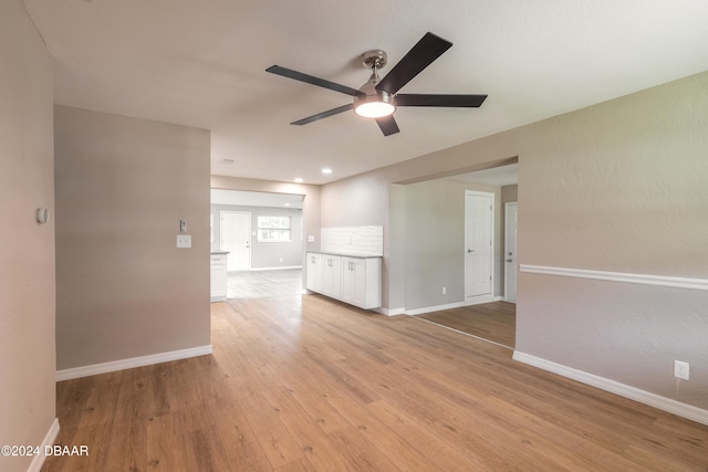 spare room with light wood-type flooring and ceiling fan