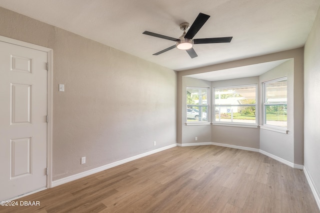 unfurnished room with ceiling fan and light hardwood / wood-style floors