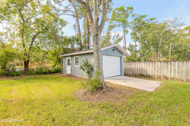 garage featuring a lawn