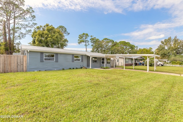 view of front of house featuring a front yard and a carport