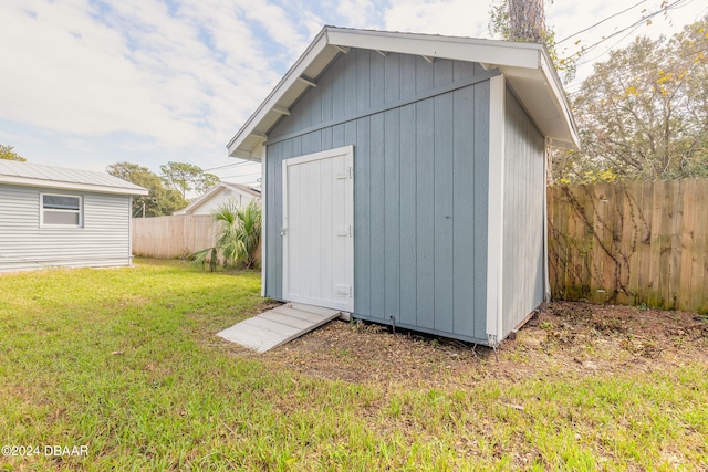 view of outdoor structure featuring a lawn