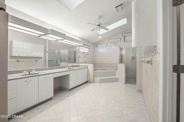 bathroom with ceiling fan, vanity, lofted ceiling, and plus walk in shower