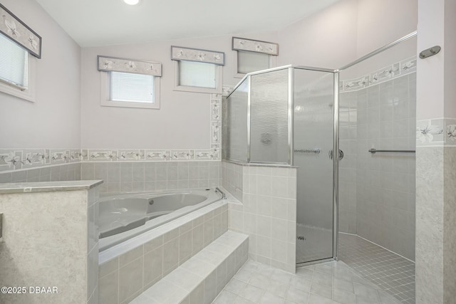 bathroom with shower with separate bathtub, tile patterned flooring, and lofted ceiling