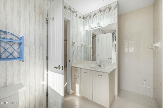 bathroom with toilet, vanity, and tile patterned flooring