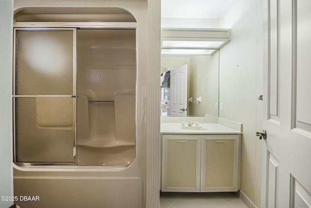 bathroom with tile patterned flooring, a shower, and vanity