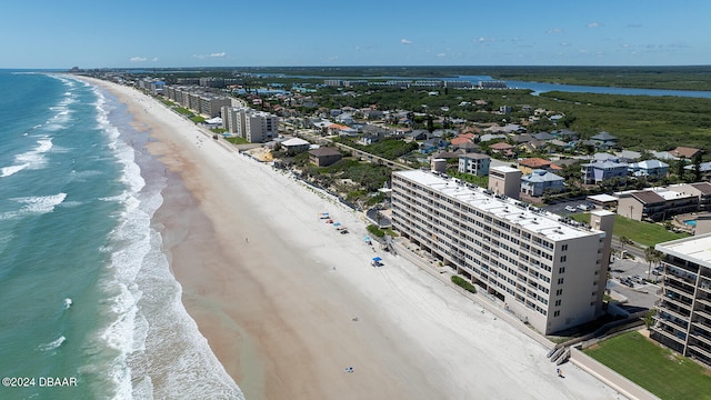 bird's eye view featuring a view of the beach and a water view