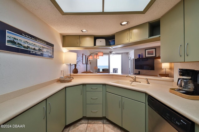 4453 S Atlantic Ave Unit 1080, Ponce Inlet, FL 32127 - kitchen with stainless steel dishwasher, green cabinets, open shelves, light countertops, and a textured ceiling