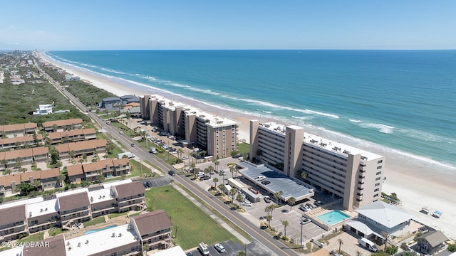 bird's eye view with a water view and a beach view