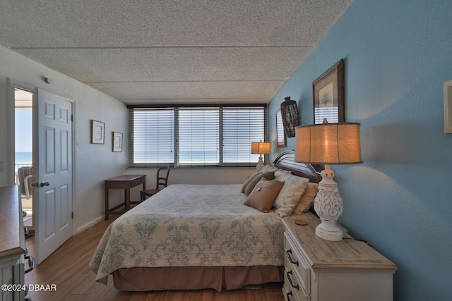 4453 S Atlantic Ave Unit 1080, Ponce Inlet, FL 32127 - bedroom with a textured ceiling and wood finished floors