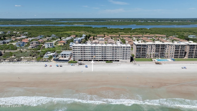 birds eye view of property with a view of the beach and a water view