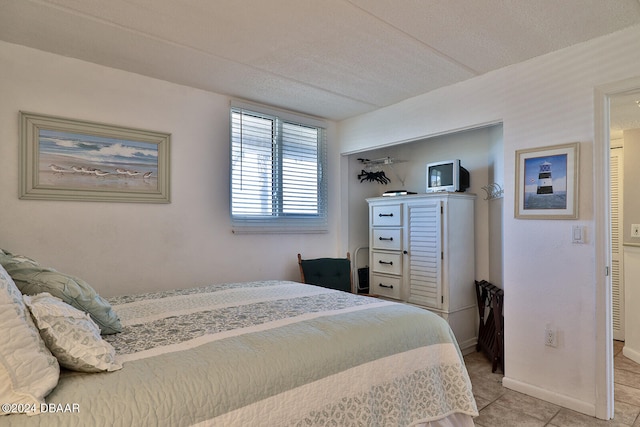 tiled bedroom with a textured ceiling