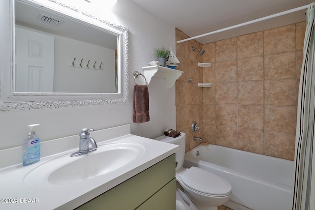 full bathroom featuring toilet, tiled shower / bath combo, and vanity