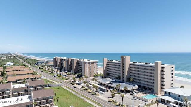 drone / aerial view featuring a beach view and a water view