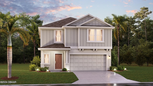 view of front facade with a yard and a garage