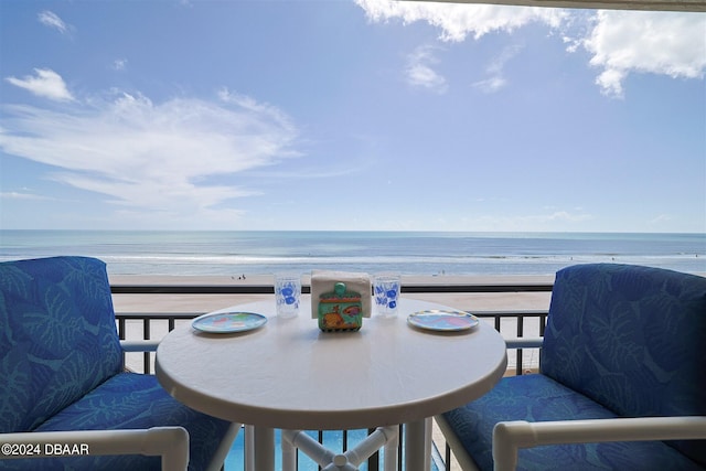 balcony with a beach view and a water view