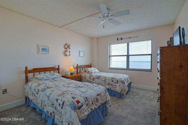 4435 S Atlantic Ave Unit 414, Ponce Inlet, FL 32127 - bedroom with carpet flooring, a textured ceiling, baseboards, and ceiling fan