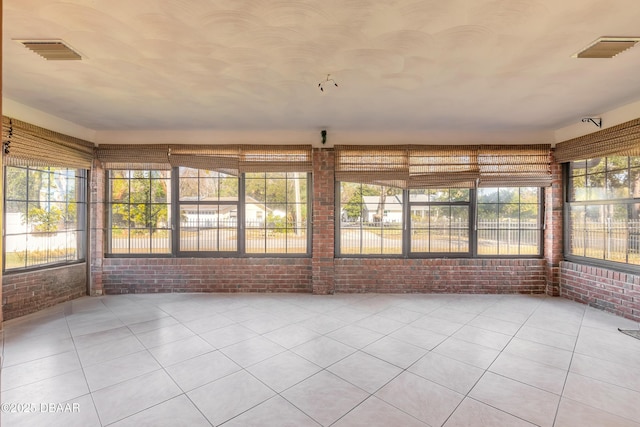 unfurnished sunroom featuring plenty of natural light