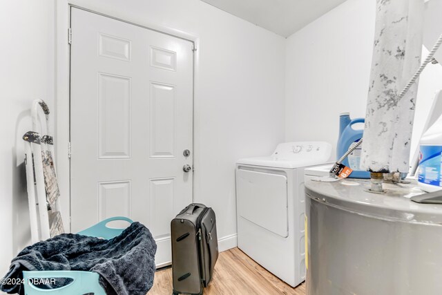 545 Cannon St, Daytona Beach, FL 32114 - washroom with water heater, independent washer and dryer, and light wood-type flooring