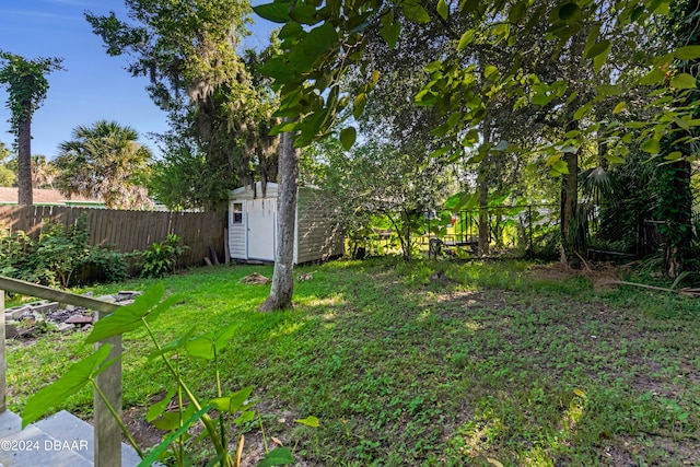 545 Cannon St, Daytona Beach, FL 32114 - fenced backyard with a storage shed and an outdoor structure