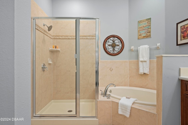 bathroom featuring vanity and separate shower and tub