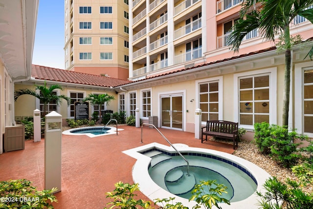 view of pool featuring a patio area and a community hot tub