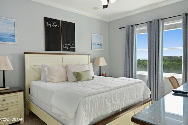 bedroom with ceiling fan, carpet, and ornamental molding