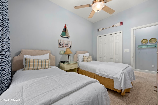 carpeted bedroom featuring ceiling fan and a closet